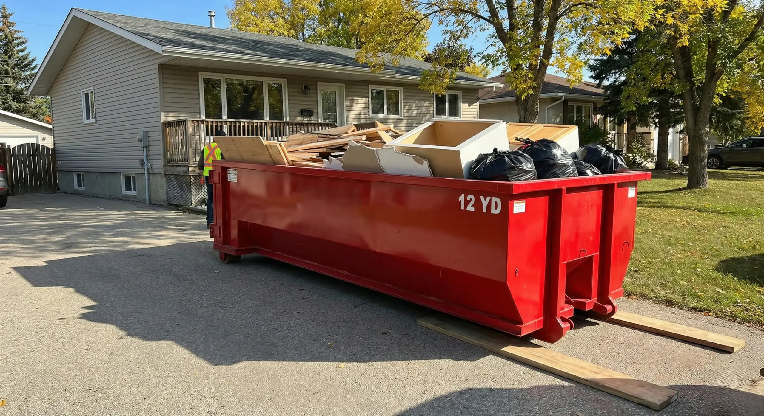 Bin rental Winnipeg showing 12-yard container on residential driveway for home renovation debris