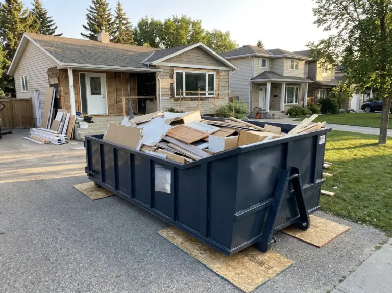 Renovation waste removal Winnipeg Ecobins 12-yard bin on residential driveway during home renovation`